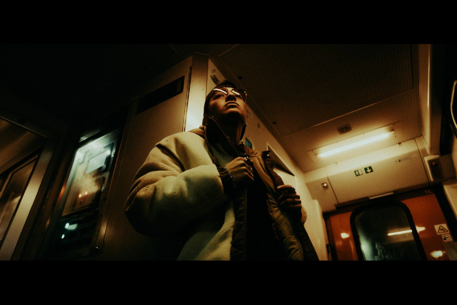 Portrait inside a train under warm fluorescent light