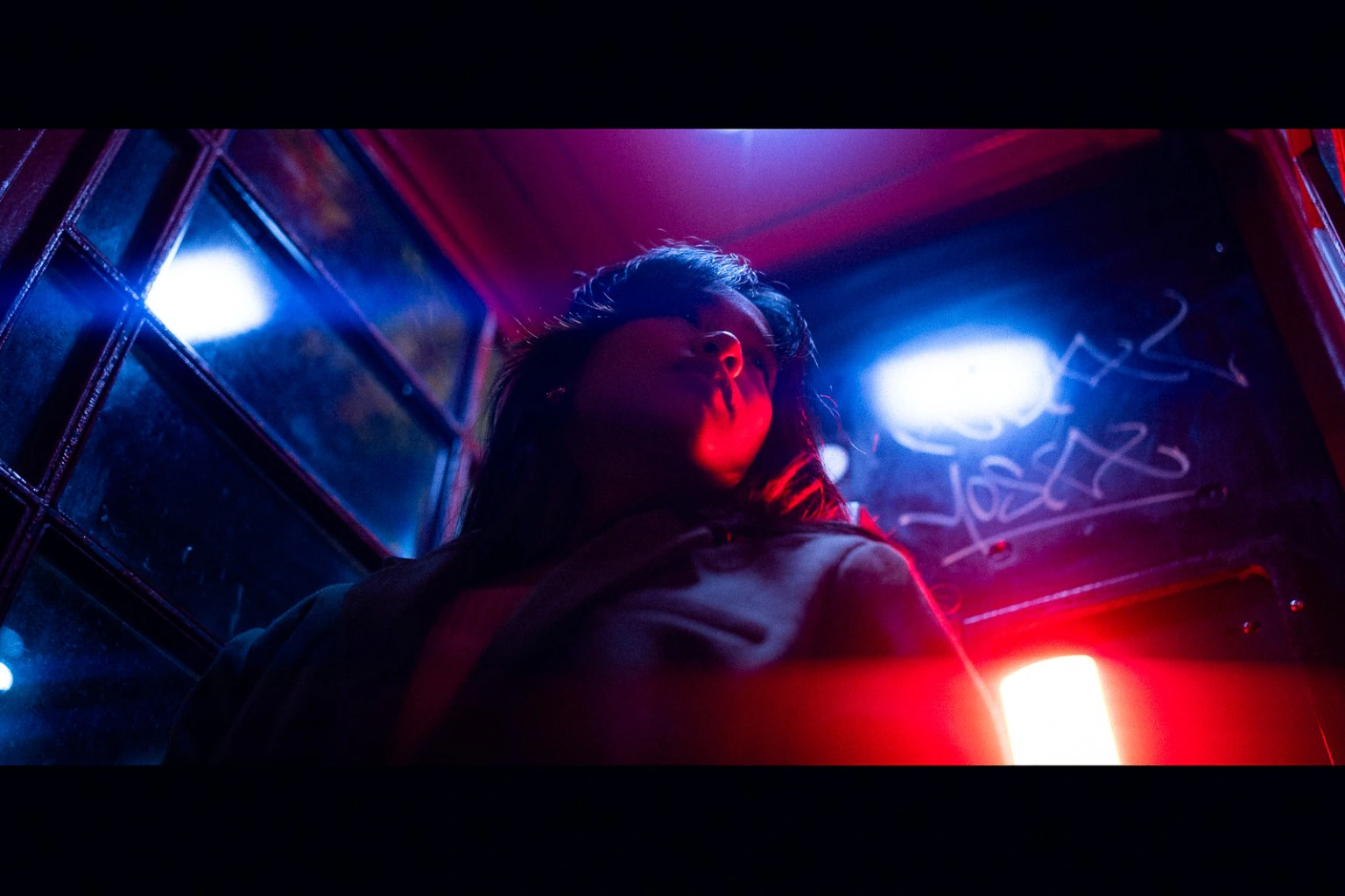 Low-angle portrait in intense red and blue light