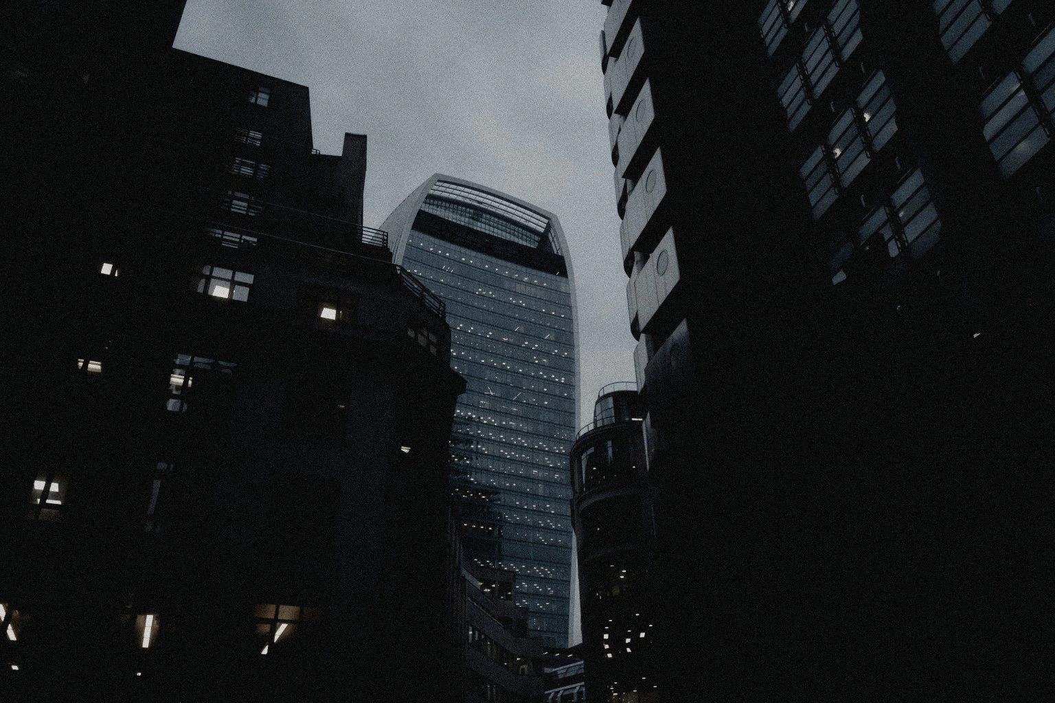 Walkie Talkie tower framed by dark London buildings