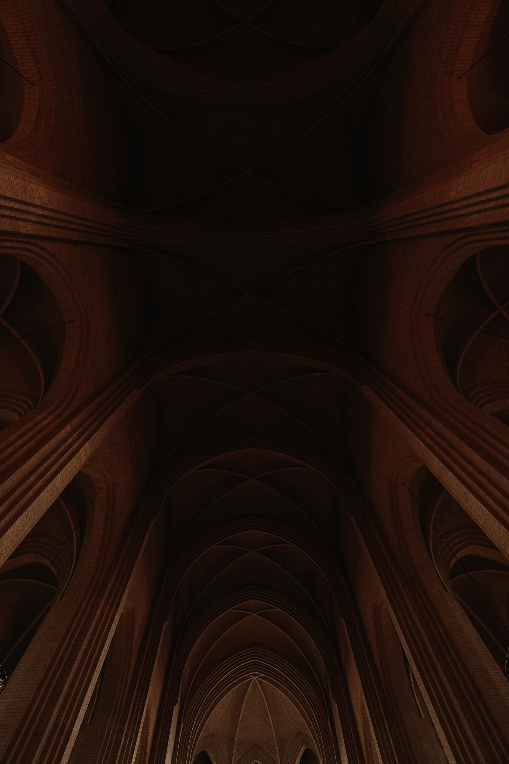 The dark intersecting brick vaults of Grundtvig's Church seen from below