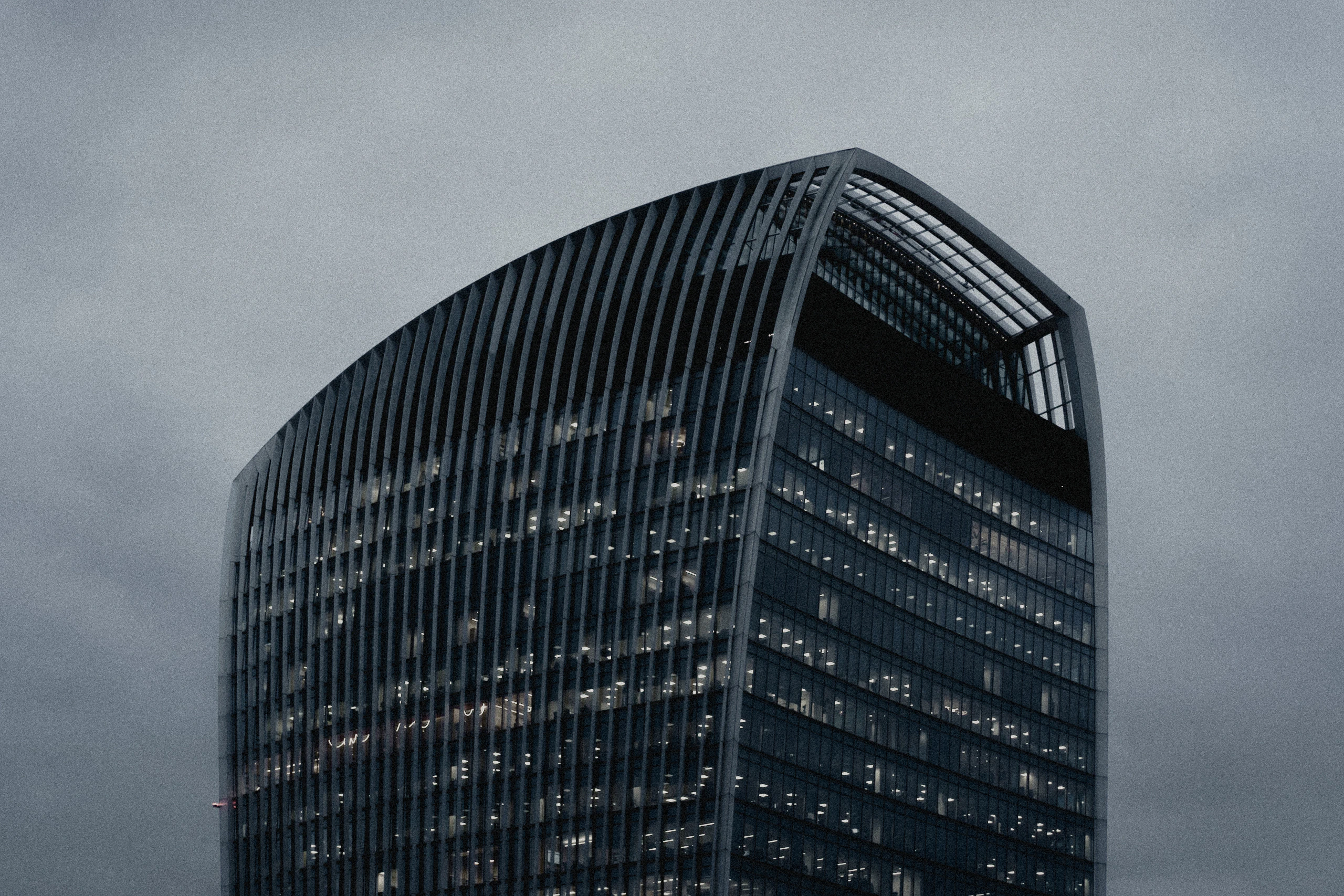 The upper floors of the Walkie Talkie building against a blank sky
