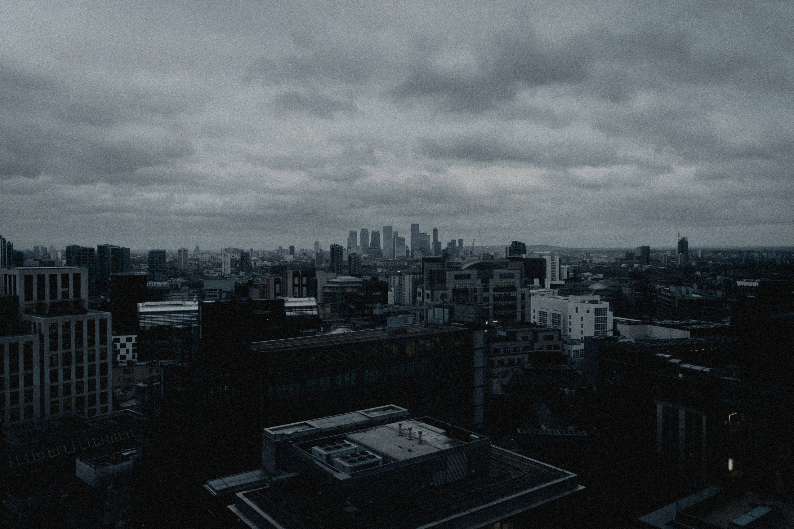 A dark London skyline beneath layered storm cloud