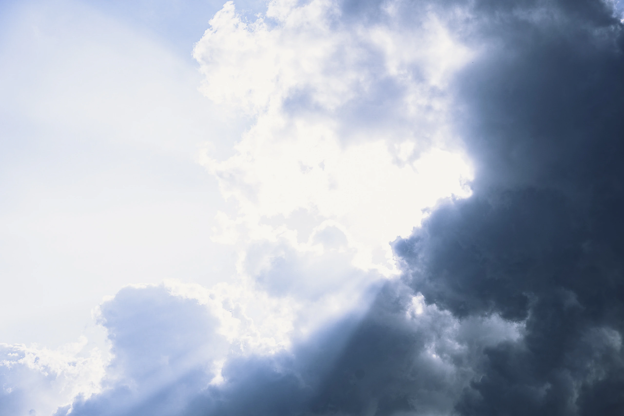 Sunlight breaking through bright and dark clouds