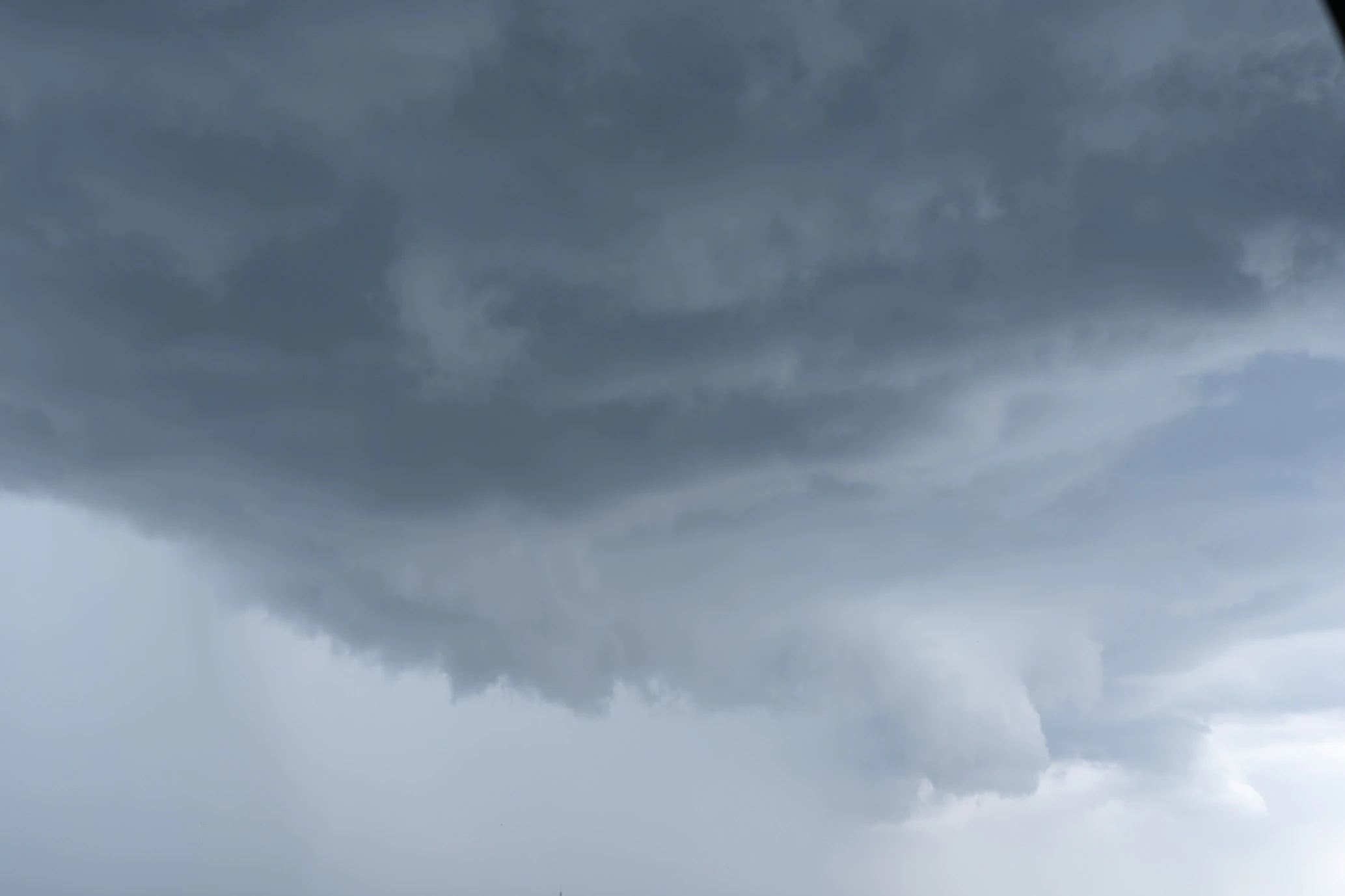 Heavy storm cloud hanging low across the sky