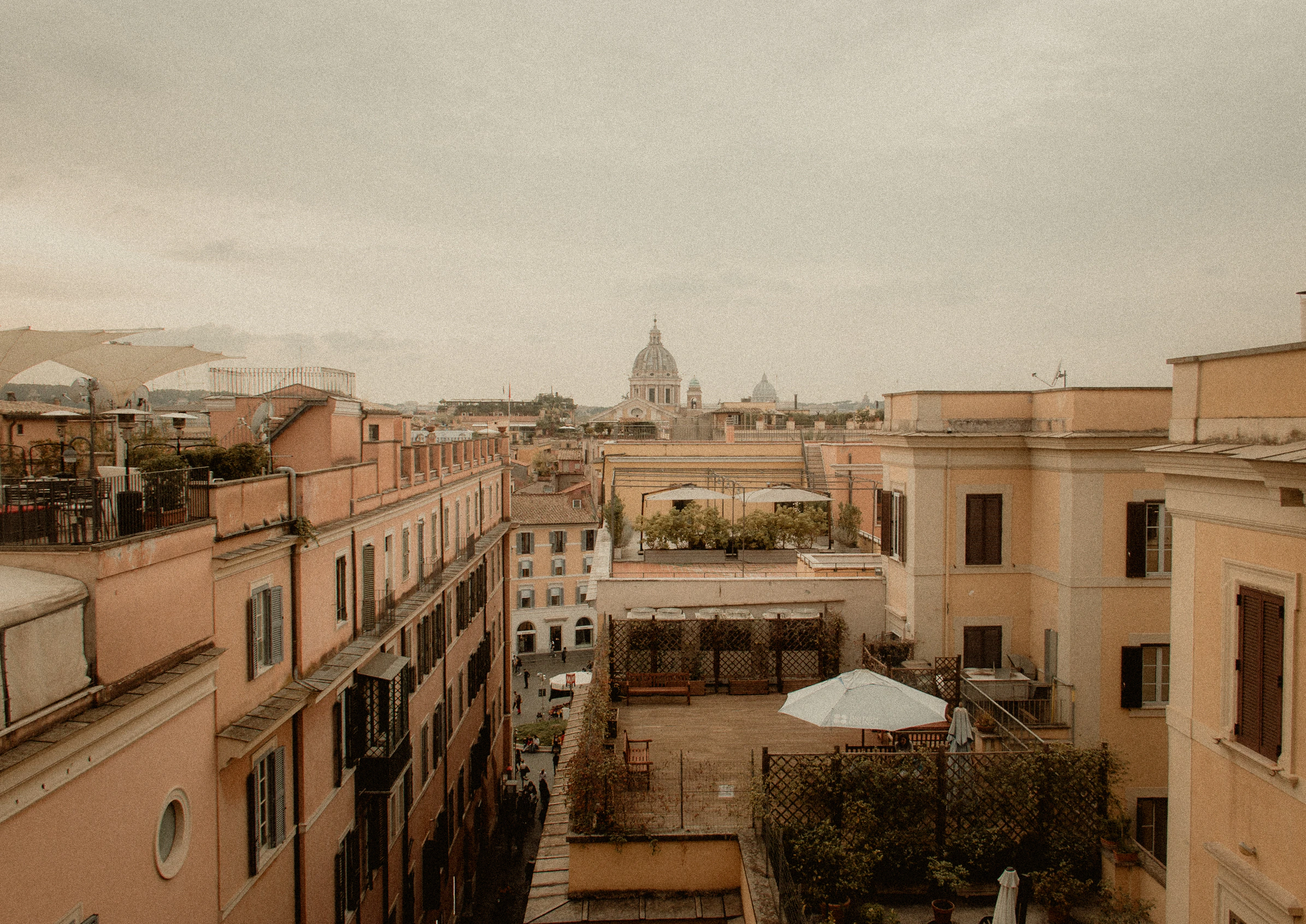 Warm Roman rooftops beneath a pale sky