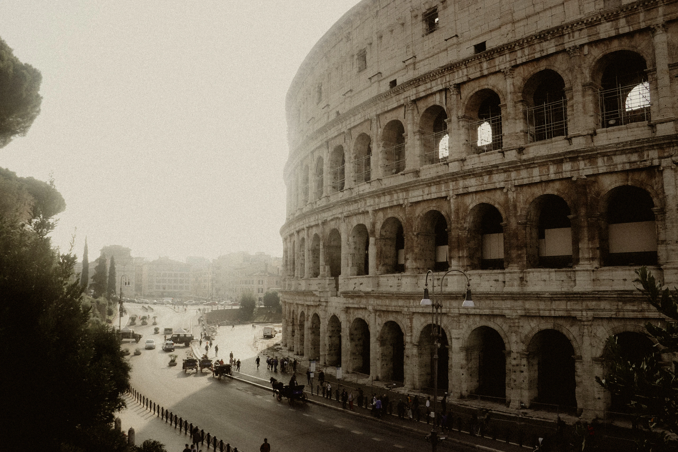 The Colosseum rising beside a hazy Roman street