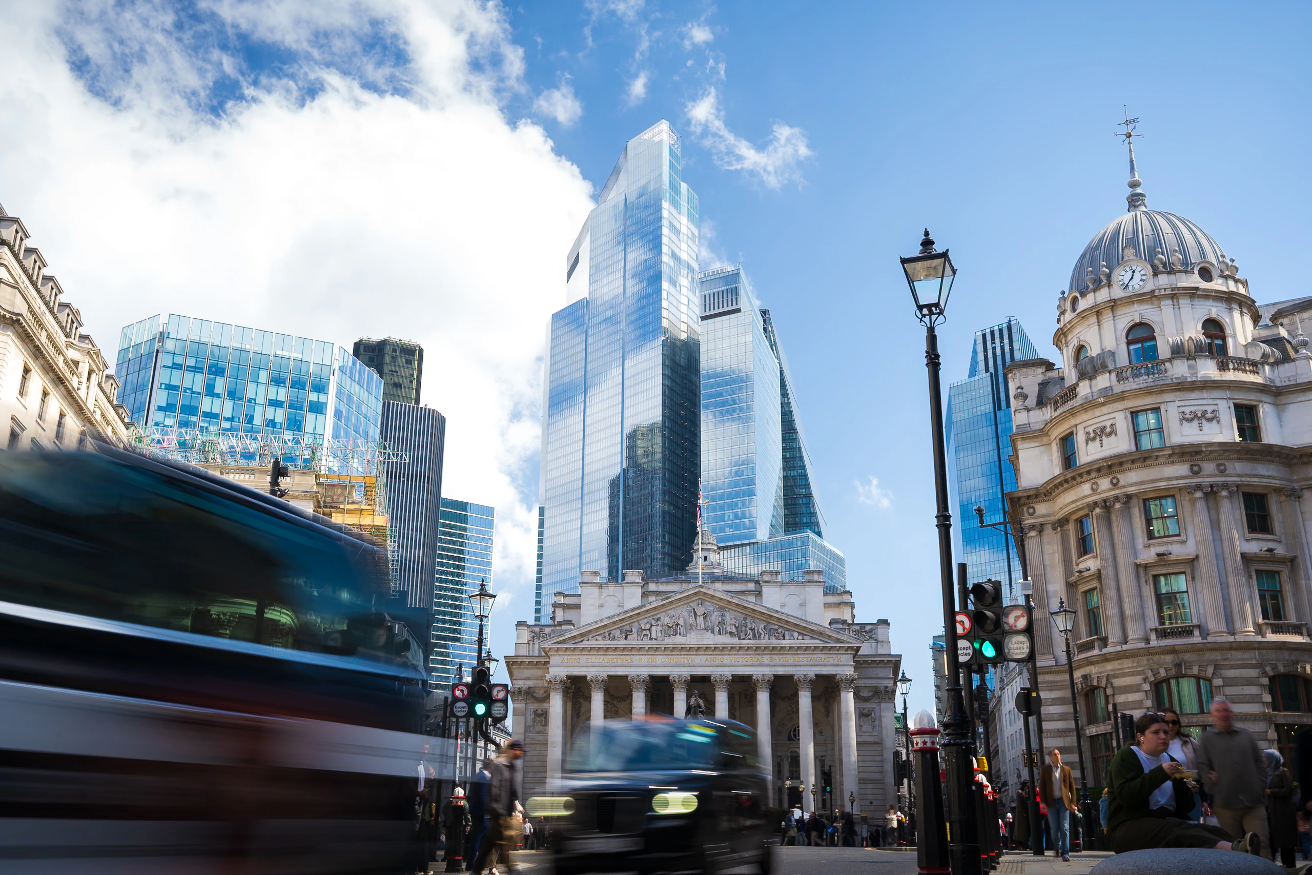 Historic and modern London architecture with traffic passing below