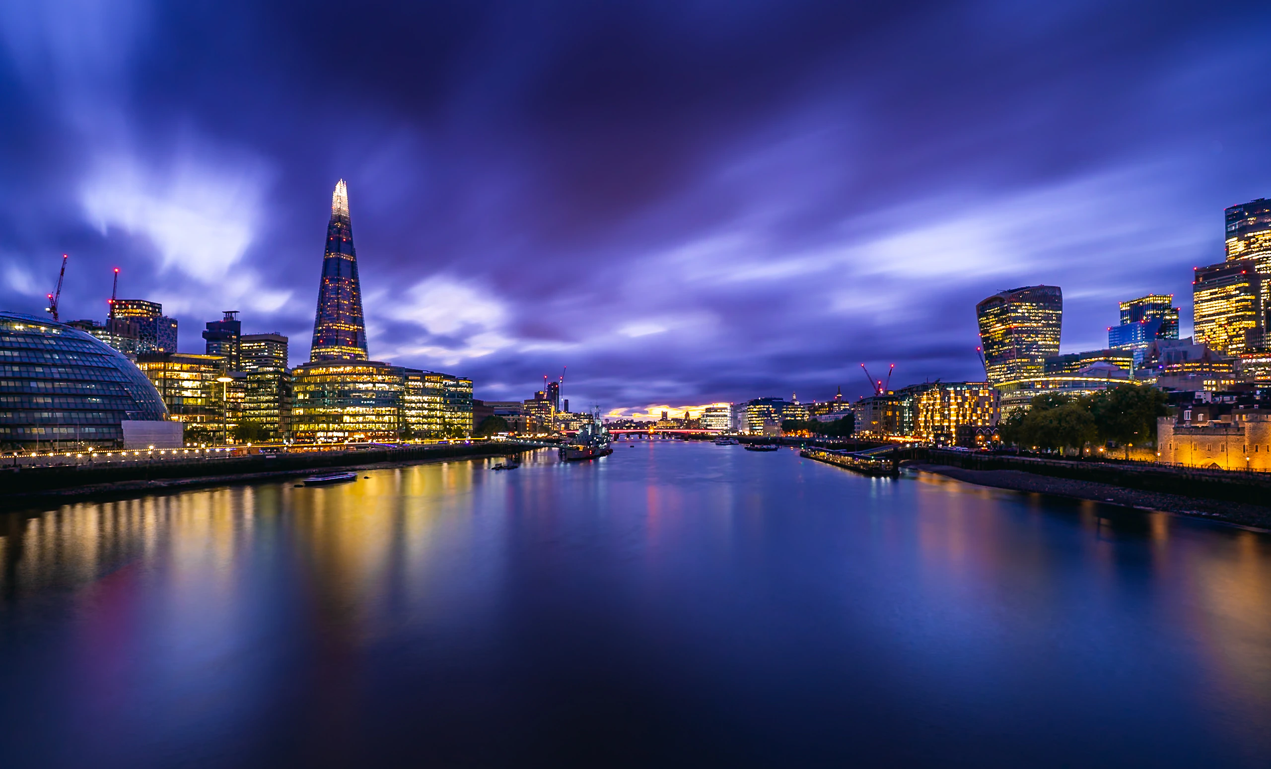 The London skyline reflected in the Thames during blue hour