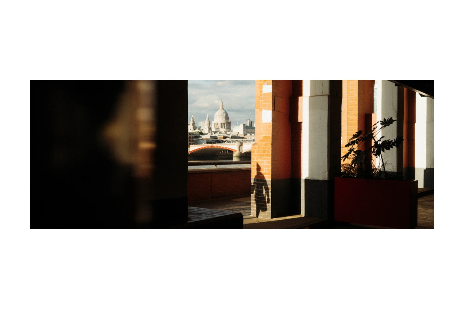 St Paul's Cathedral glimpsed through warm modern architecture