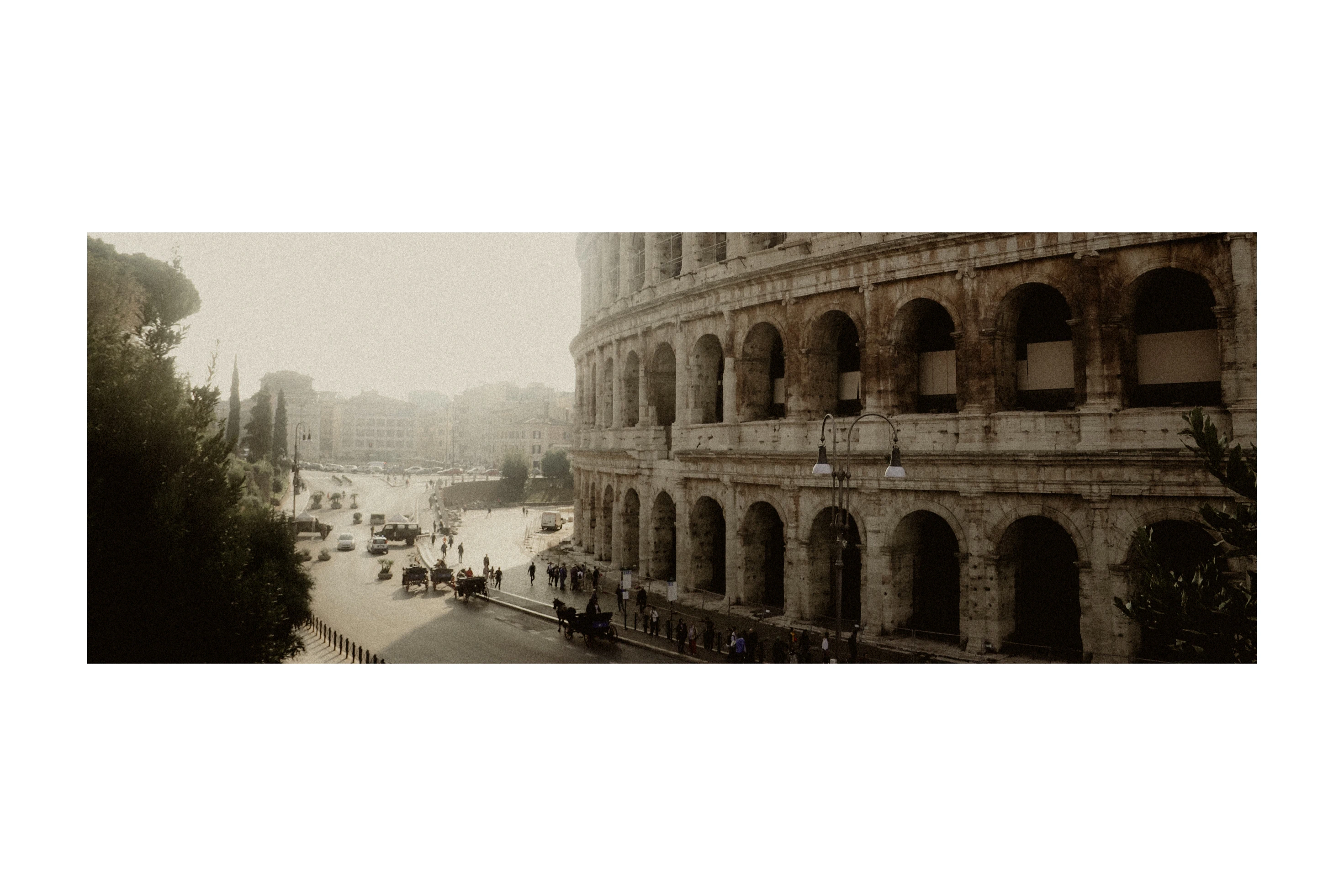 The Colosseum and surrounding streets in warm haze